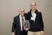 Dr. Nagib Callaos, General Chair, giving Prof. David González Ortega a plaque "Por su Excelente Ponencia Plenaria."